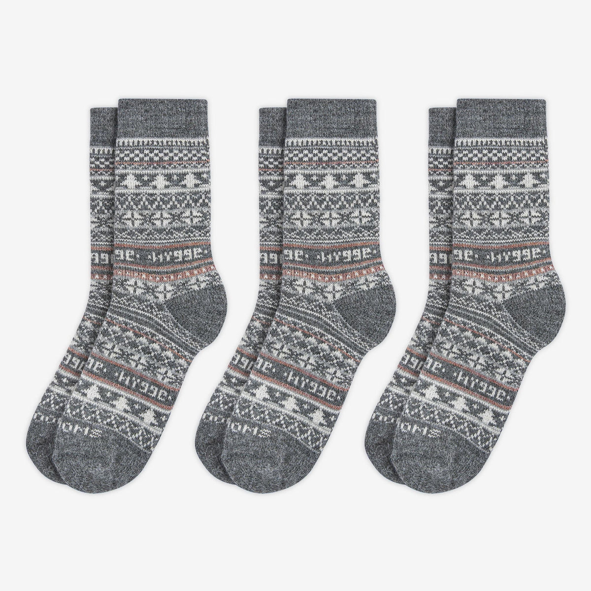 3 pairs pack of grey patterned merino wool Swoollies socks with the text 'hygge' knitted on it. The socks are thick. Socks are on a light grey background