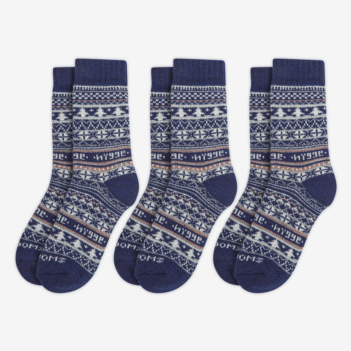 3 pairs pack of navy blue patterned merino wool Swoollies socks with the text 'hygge' knitted on it. The socks are thick. Socks are on a light grey background