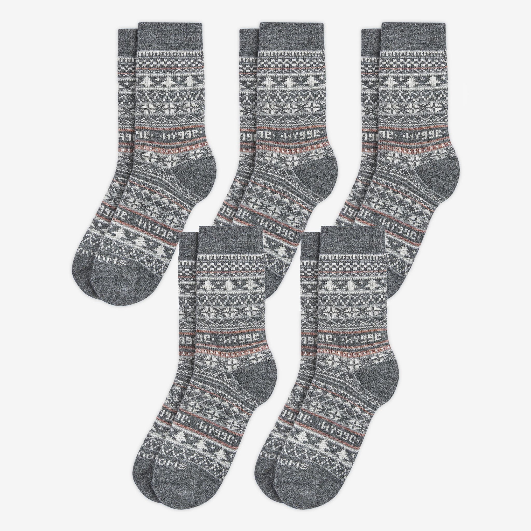 5 pairs pack of grey patterned merino wool Swoollies socks with the text 'hygge' knitted on it. The socks are thick. Socks are on a light grey background