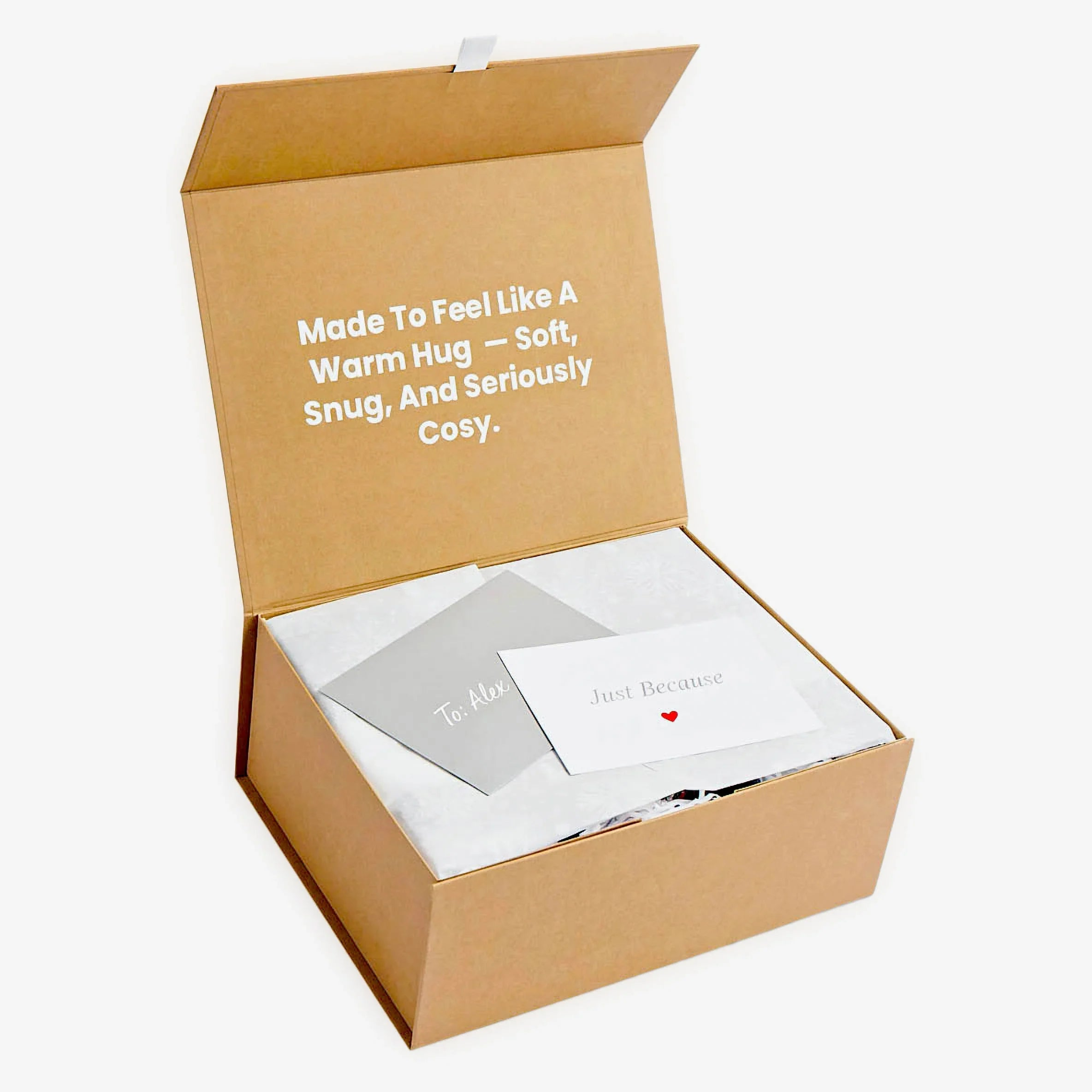 Open Swoollies magnetic kraft gift box showcasing the text 'Made To Feel Like A Warm Hug' on its lid, and custom gift note inside it. The box is on a light grey background