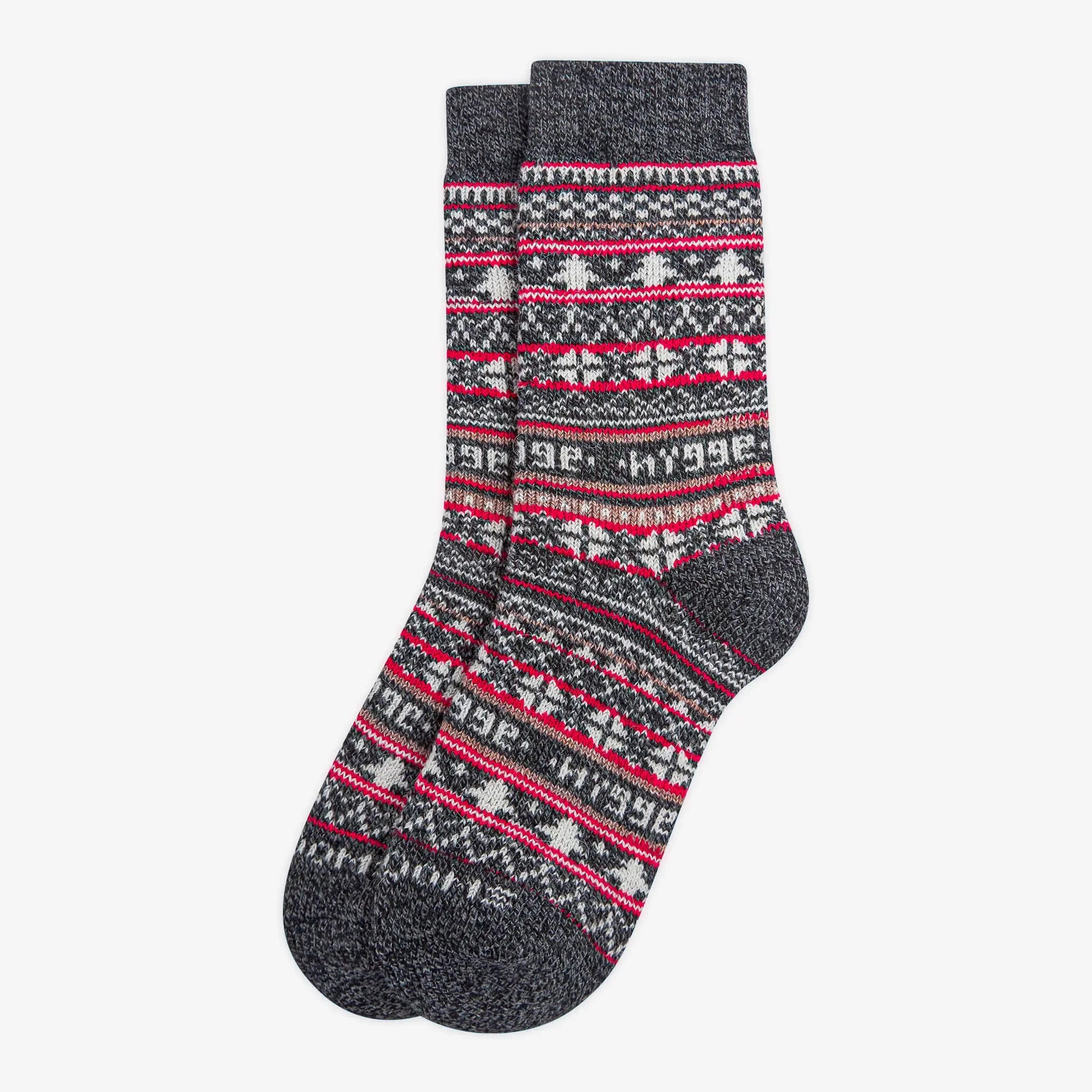 Pair of charcoal merino wool Swoollies socks with red and white pattern, on a light grey background